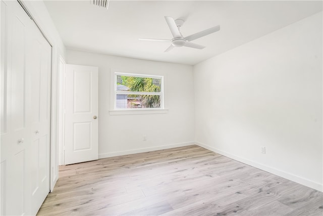 spare room featuring light hardwood / wood-style flooring and ceiling fan