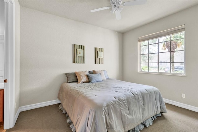 bedroom with baseboards, ceiling fan, and carpet flooring