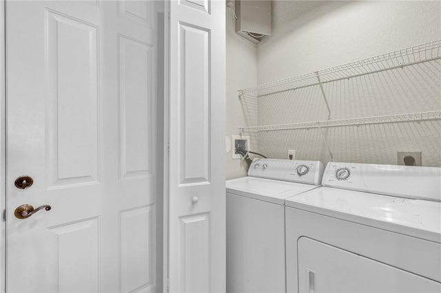 clothes washing area featuring laundry area and washer and dryer