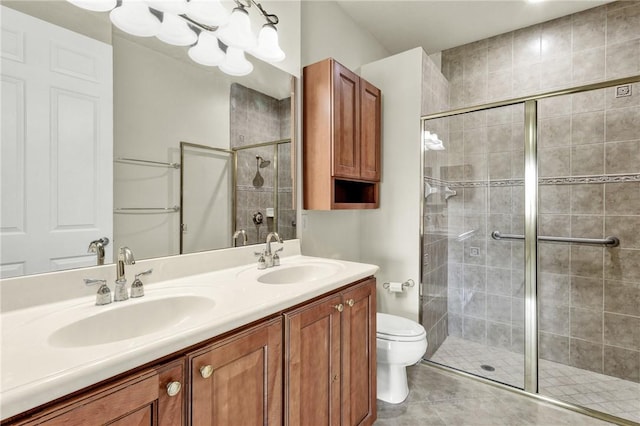 bathroom featuring double vanity, a sink, and a stall shower