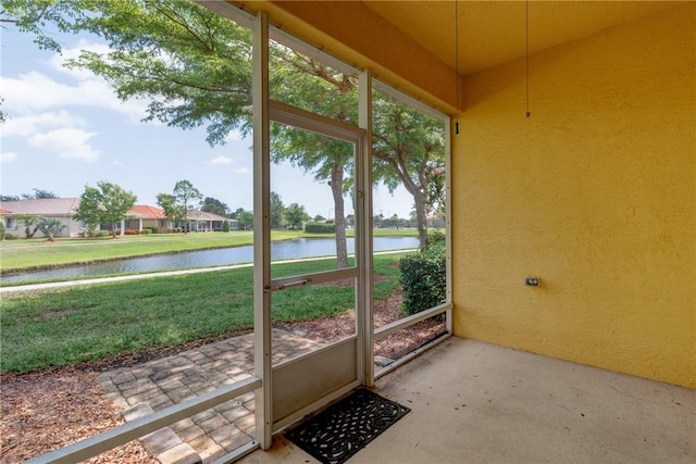 unfurnished sunroom with a water view