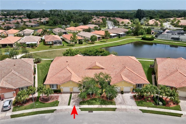 bird's eye view featuring a water view and a residential view