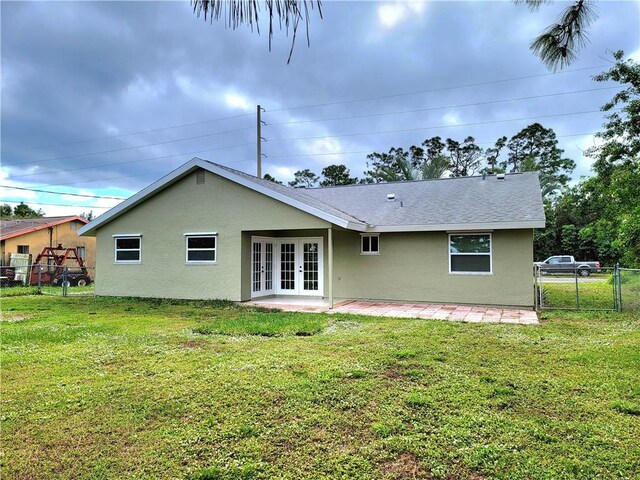 back of house with a patio, a yard, and french doors