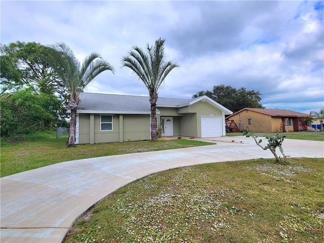 single story home with a garage and a front lawn