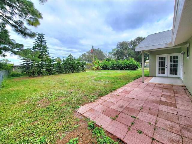 view of yard featuring a patio area and french doors