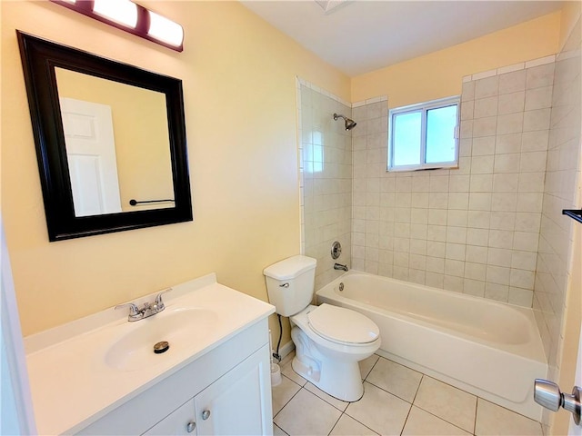 full bathroom featuring toilet, tiled shower / bath, tile patterned floors, and vanity