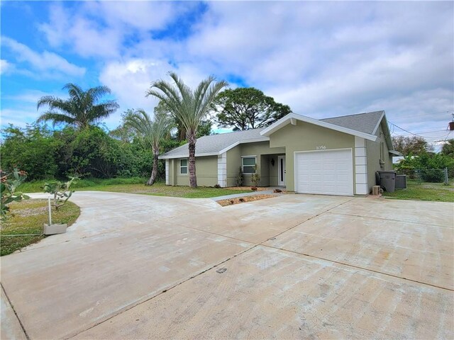 single story home featuring a garage and a front lawn