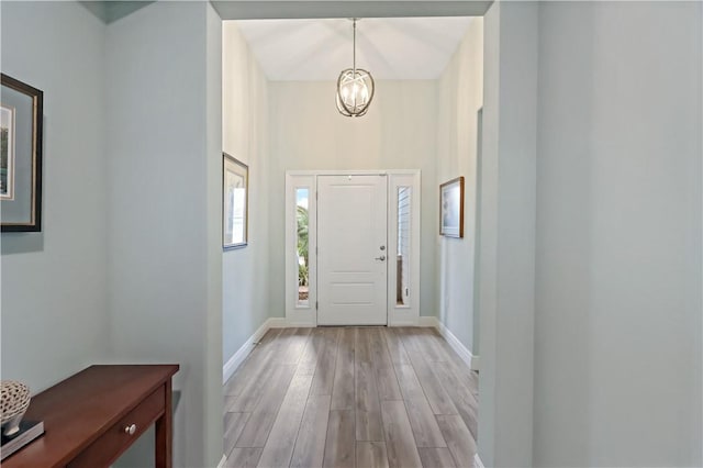 entrance foyer featuring a notable chandelier and light hardwood / wood-style floors