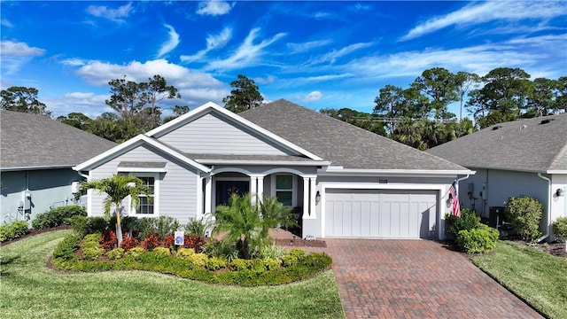 ranch-style house featuring a garage and a front yard