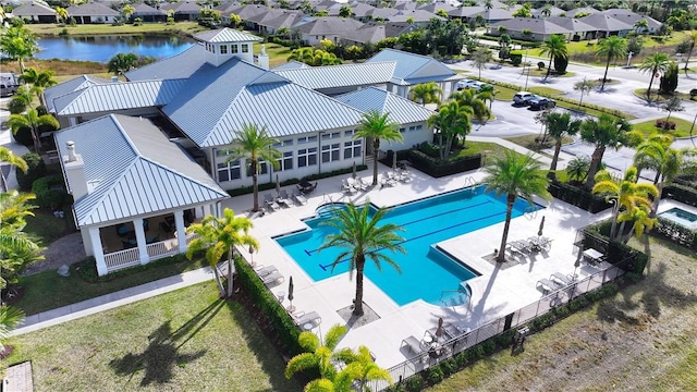 view of pool with a patio and a water view