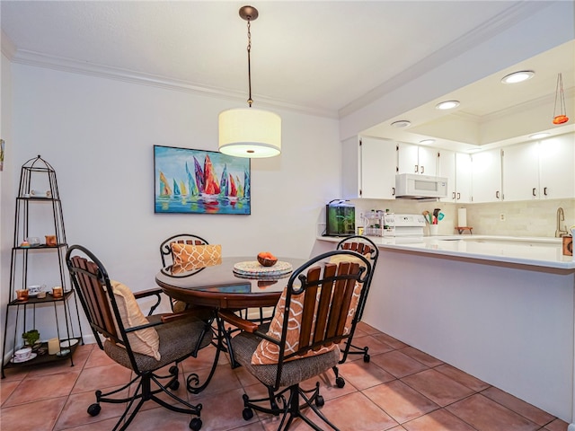 tiled dining room with ornamental molding