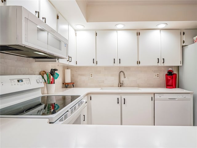 kitchen featuring white cabinets, white appliances, sink, and tasteful backsplash