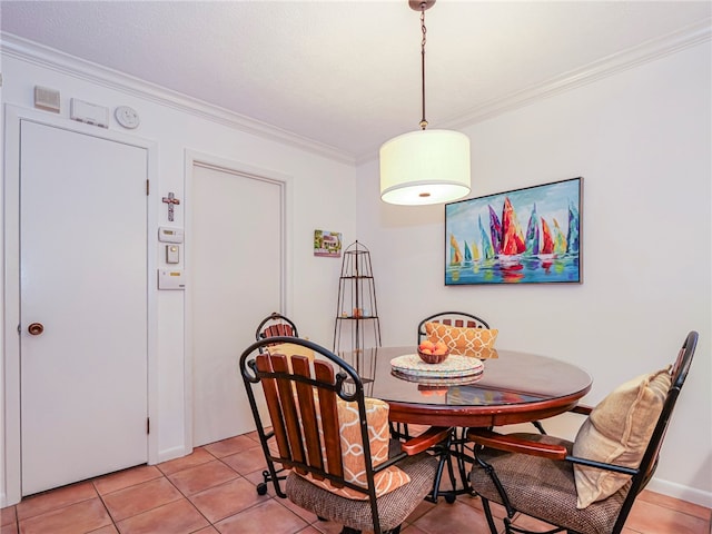 tiled dining area featuring ornamental molding