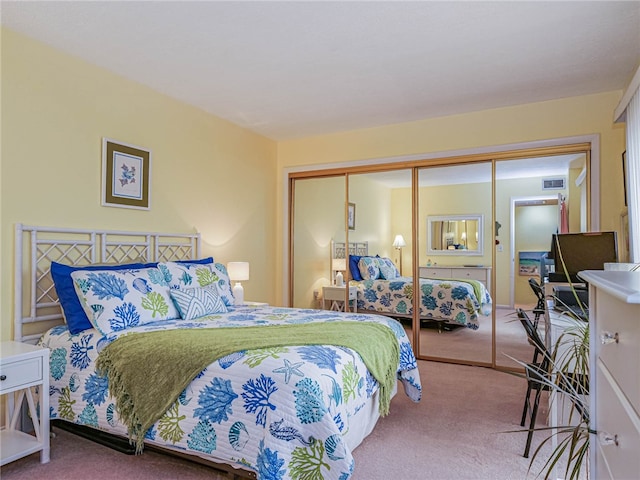 bedroom with carpet flooring and a closet