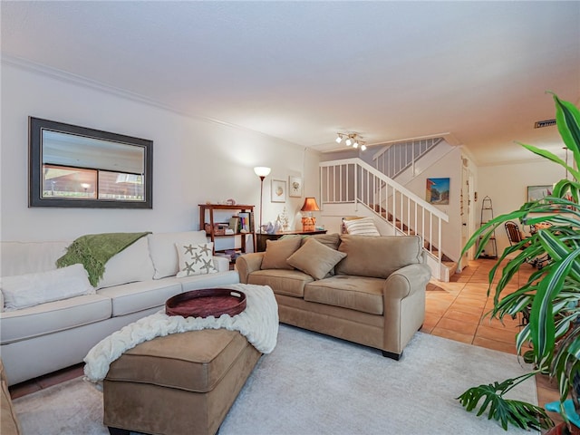 living room with light tile patterned flooring and ornamental molding