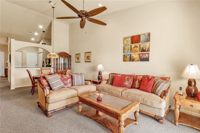 carpeted living room featuring high vaulted ceiling and ceiling fan