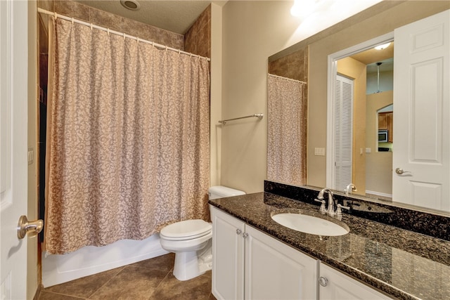 bathroom featuring tile patterned floors, vanity, and toilet