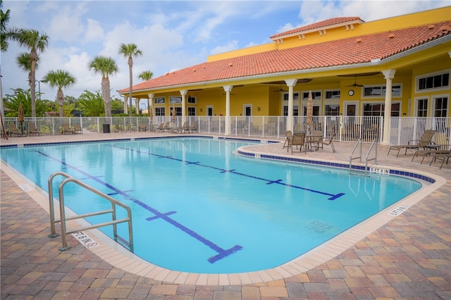 view of pool featuring ceiling fan and a patio