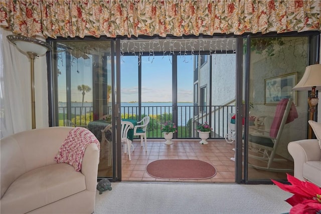 living room with a water view and carpet floors