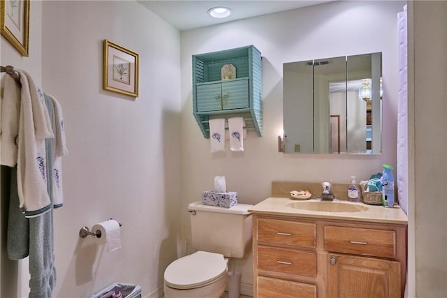 bathroom featuring vanity and toilet