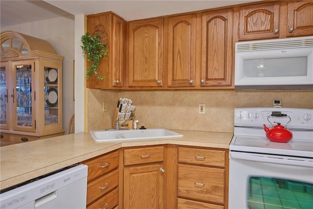 kitchen with sink, white appliances, and decorative backsplash