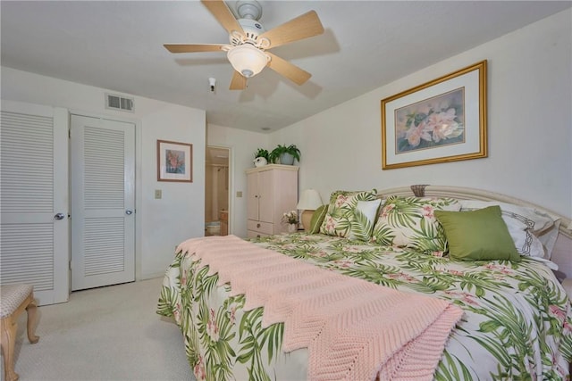 carpeted bedroom featuring a closet and ceiling fan