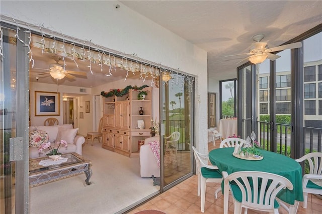 sunroom / solarium featuring ceiling fan