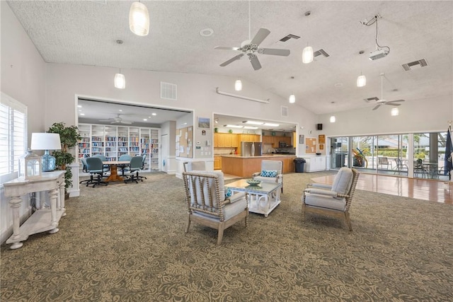 living room with ceiling fan, high vaulted ceiling, carpet, and a textured ceiling