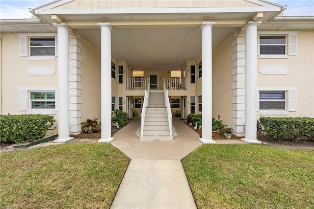 view of exterior entry featuring a yard