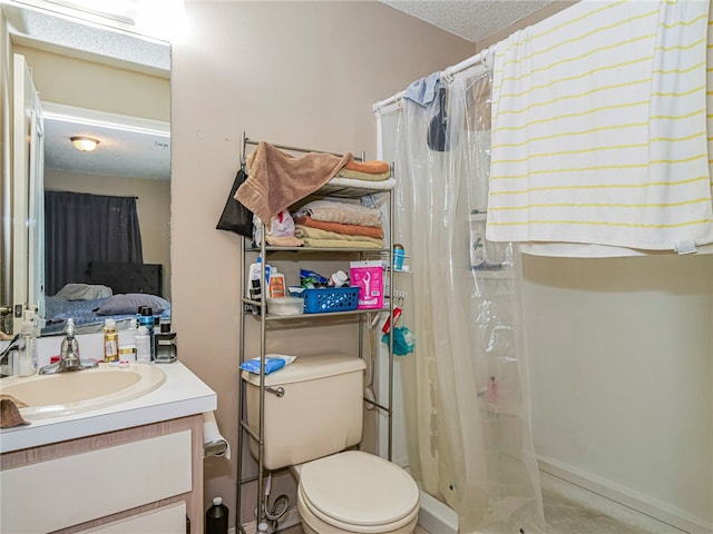 bathroom featuring curtained shower, vanity, a textured ceiling, and toilet