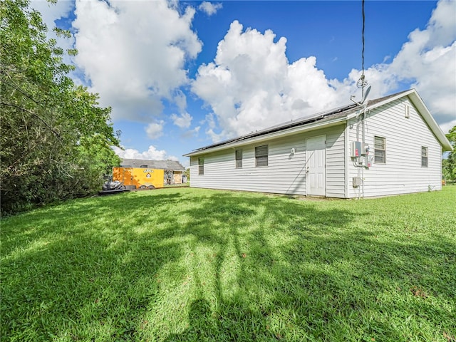 rear view of house with a yard