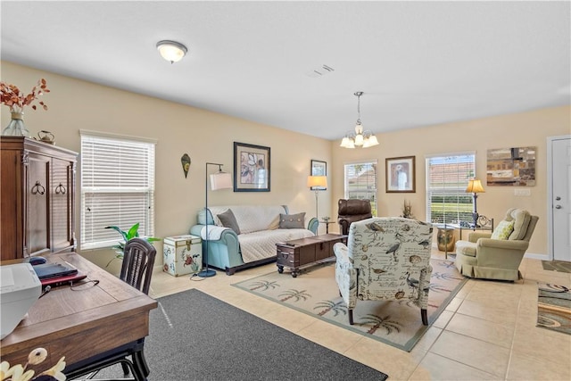 living room featuring light tile patterned floors and a chandelier