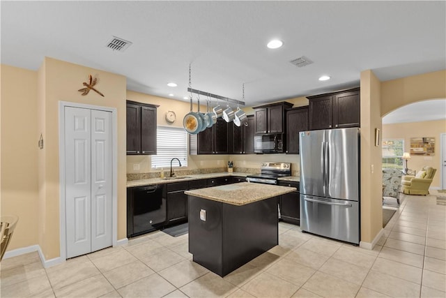 kitchen with sink, a center island, dark brown cabinets, light tile patterned floors, and black appliances