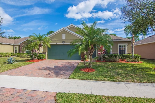 ranch-style home featuring a garage and a front yard