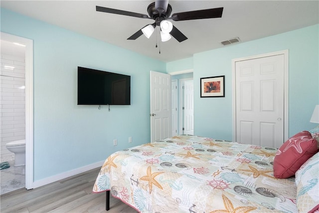 1203 Linmoor Cir NE, Palm Bay, FL 32907 - bedroom with wood finished floors, a ceiling fan, ensuite bathroom, and baseboards