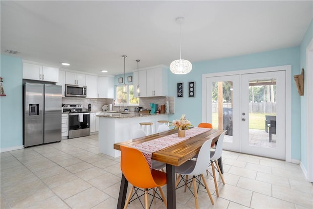 1203 Linmoor Cir NE, Palm Bay, FL 32907 - dining area featuring french doors, light tile patterned flooring, recessed lighting, a chandelier, and baseboards