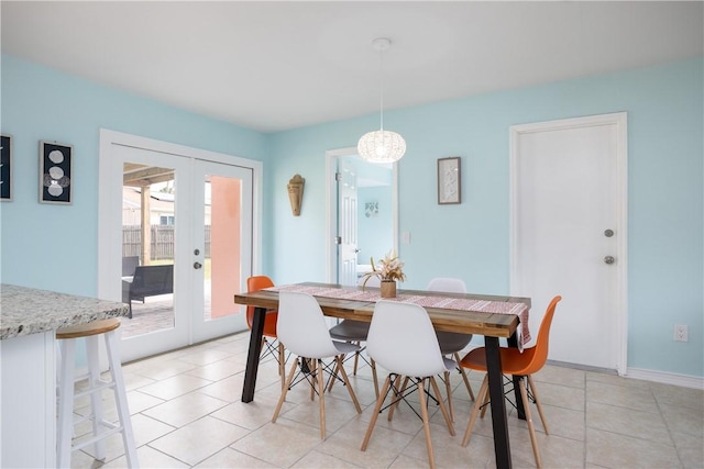 1203 Linmoor Cir NE, Palm Bay, FL 32907 - dining room with french doors, a chandelier, light tile patterned floors, and baseboards