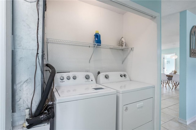 1203 Linmoor Cir NE, Palm Bay, FL 32907 - laundry area with washing machine and clothes dryer and light tile patterned flooring