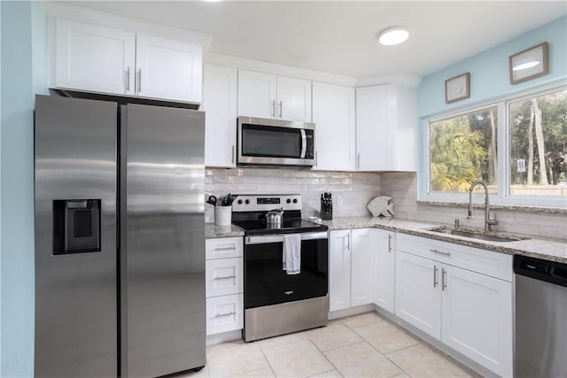 1203 Linmoor Cir NE, Palm Bay, FL 32907 - kitchen featuring stainless steel appliances, a sink, light tile patterned floors, and decorative backsplash