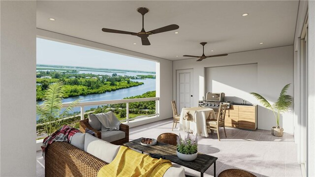 sunroom featuring a ceiling fan and a water view