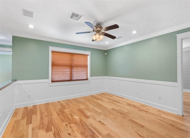 empty room with wood-type flooring, ornamental molding, and ceiling fan