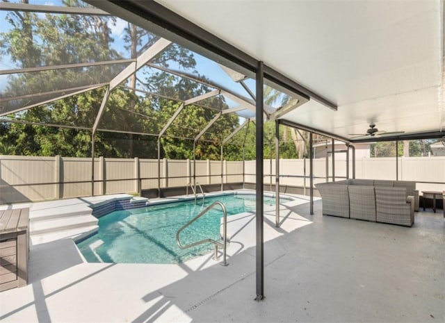 view of pool featuring an outdoor hangout area, glass enclosure, and a patio area