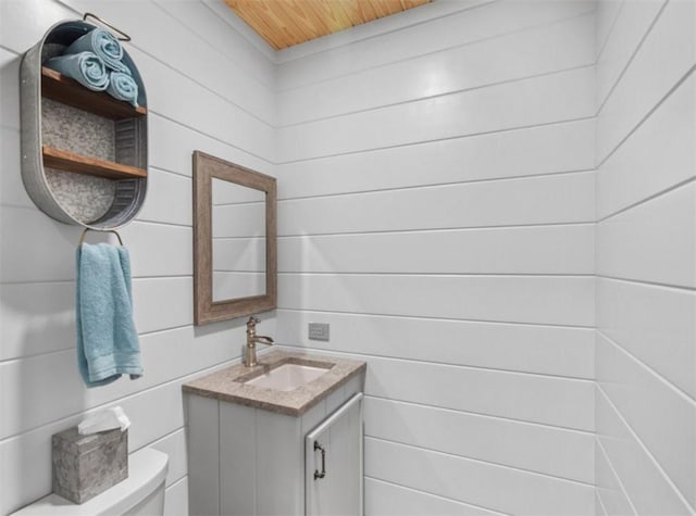 bathroom with vanity, wood ceiling, and toilet