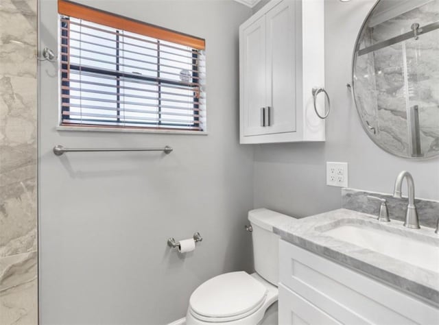 bathroom with vanity, toilet, and an enclosed shower