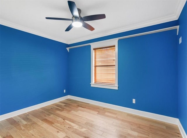 spare room with ceiling fan, ornamental molding, and light wood-type flooring