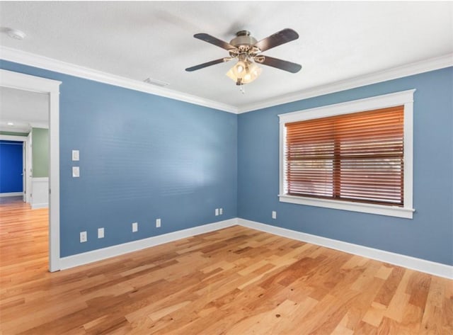 spare room with crown molding, hardwood / wood-style floors, and ceiling fan