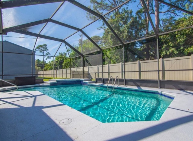 view of swimming pool with a lanai and a patio