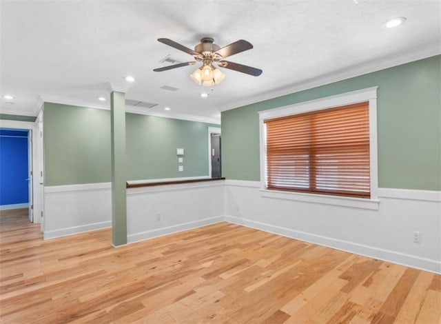 empty room featuring ornamental molding, ceiling fan, and light hardwood / wood-style floors