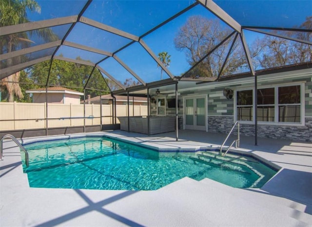 view of swimming pool with outdoor lounge area, a lanai, and a patio