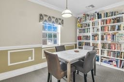 dining space with ornamental molding